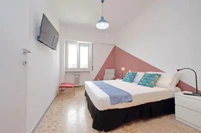 a hotel room with a bed and a tv at Comfy home for family next to Metro in Rome