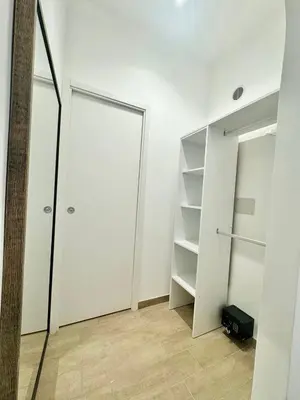 a white room with a closet and a mirror at Little Apartment in Rome