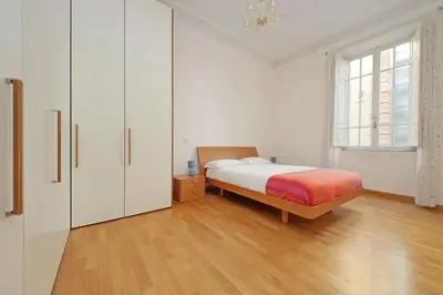 a bedroom with a bed and a dresser at At the Vatican Ottaviano 2 bedrooms 2 baths in Rome