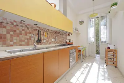 a kitchen with wooden cabinets and a sink at At the Vatican Ottaviano 2 bedrooms 2 baths in Rome