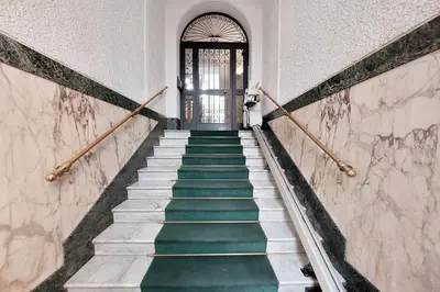 a stairway leading to a door with green stairs at At the Vatican Ottaviano 2 bedrooms 2 baths in Rome