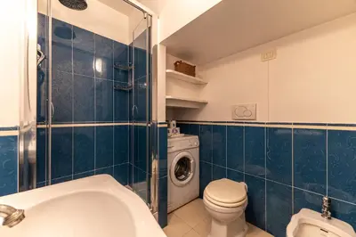 a bathroom with a toilet sink and a washing machine at Piazza Navona Elite Flat in Rome