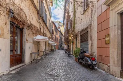 an alley in an old town with a scooter parked at Piazza Navona Elite Flat in Rome