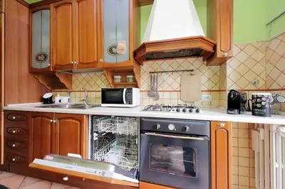 a kitchen with an oven with a dishwasher in it at Aria di Roma Appartamento in Rome