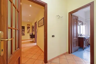 a hallway with a door leading to a bathroom at Aria di Roma Appartamento in Rome