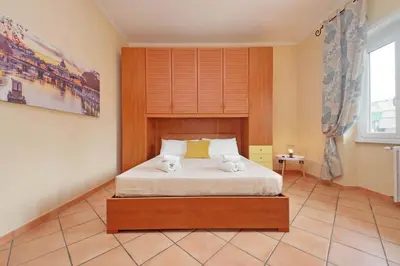 a bedroom with a bed with two towels on it at Aria di Roma Appartamento in Rome