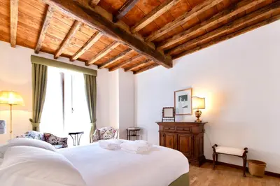 a bedroom with a white bed and a wooden ceiling at Casa Acerbo - Rome Navona Apartment in Rome
