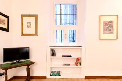 a living room with a tv and a window at Casa Acerbo - Rome Navona Apartment in Rome