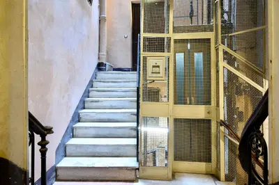 a staircase in a building with a gate and a stair case at Casa Acerbo - Rome Navona Apartment in Rome