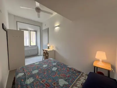 a bedroom with a bed and a lamp and a window at Casa dolce Roma Prati in Rome