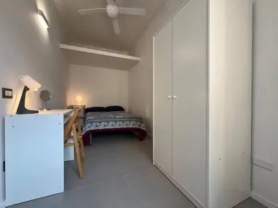 a bedroom with a bed and a desk and a ceiling at Casa dolce Roma Prati in Rome