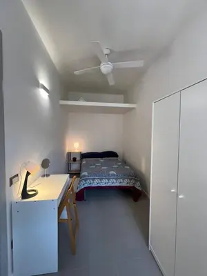 a bedroom with a bed and a desk and a ceiling at Casa dolce Roma Prati in Rome