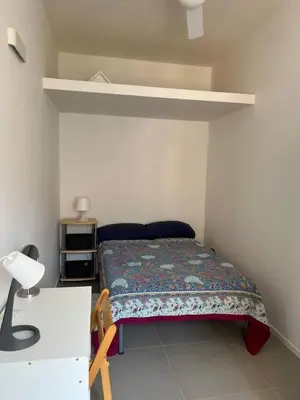 a small bedroom with a bed and a desk at Casa dolce Roma Prati in Rome