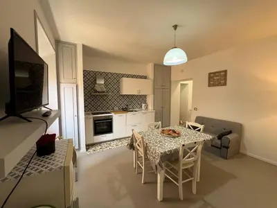 a kitchen and dining room with a table and chairs at Casa dolce Roma Prati in Rome