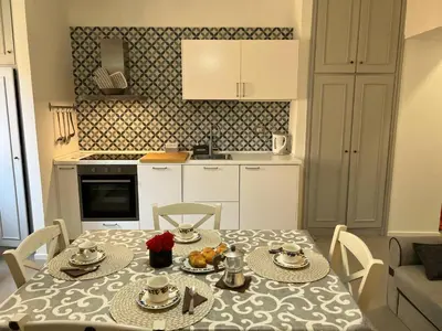 a kitchen with a table and a table and chairs at Casa dolce Roma Prati in Rome