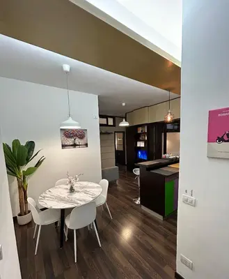 a dining room and kitchen with a table and chairs at Candelor House - Apartment & Garden Trastevere in Rome