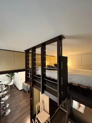 a bedroom with a large bed and a desk at Candelor House - Apartment & Garden Trastevere in Rome