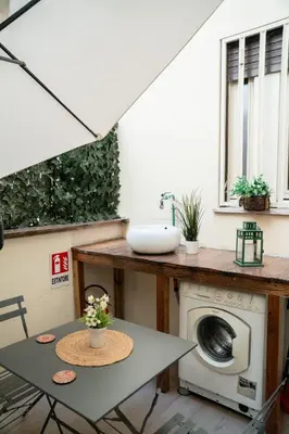 a laundry room with a sink and a washing machine at Candelor House - Apartment & Garden Trastevere in Rome