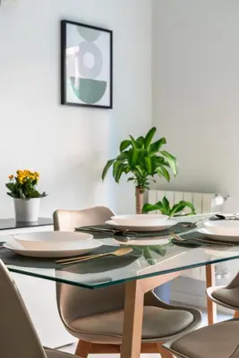 a dining room with a glass table and chairs at alPigneto Apartment Rome in Rome