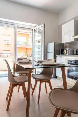a kitchen with a glass table and two chairs at alPigneto Apartment Rome in Rome