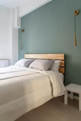 a bedroom with a large bed with a wooden headboard at alPigneto Apartment Rome in Rome