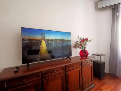 a flat screen tv sitting on top of a wooden cabinet at Cipro Home in Rome