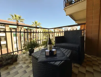 a bottle of wine sitting on a table on a balcony at Luminous 2BR Family Apartment in Residential Area in Rome