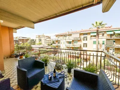 a balcony with chairs and a table on a balcony at Luminous 2BR Family Apartment in Residential Area in Rome