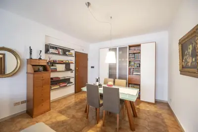 a kitchen and dining room with a table and chairs at Luminous 2BR Family Apartment in Residential Area in Rome