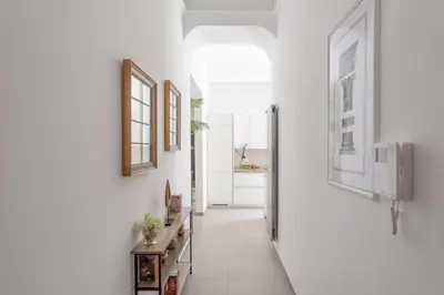 a hallway of a home with white walls and white floors at iFlat Soft & Relaxing apt in Trastevere in Rome