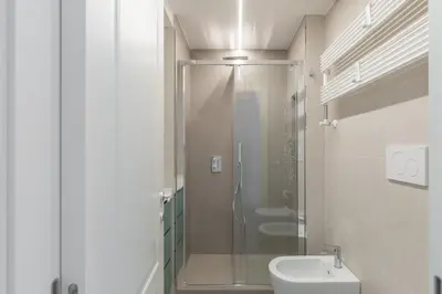 a bathroom with a shower with a toilet and a sink at iFlat Soft & Relaxing apt in Trastevere in Rome