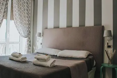 a bedroom with a bed with two towels on it at B&B Exa Rooms - Just Rome in Rome