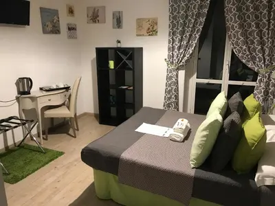 a bedroom with a bed and a desk and a window at B&B Exa Rooms - Just Rome in Rome
