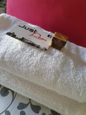 a box of justipop sitting on top of towels at B&B Exa Rooms - Just Rome in Rome