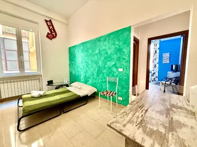 a bedroom with a bed and a green wall at Casa Flavia in Rome