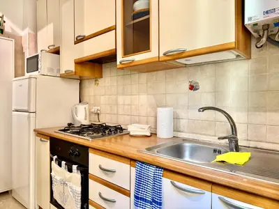 a kitchen with a sink and a refrigerator at Casa Flavia in Rome