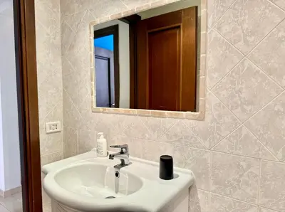 a bathroom with a sink and a mirror at Casa Flavia in Rome