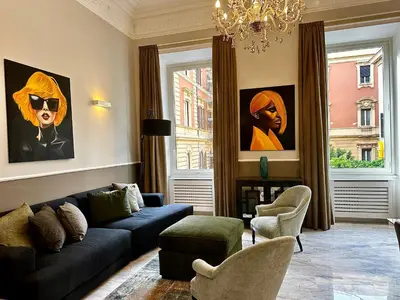 a living room with a blue couch and a window at The Great Maison in Rome