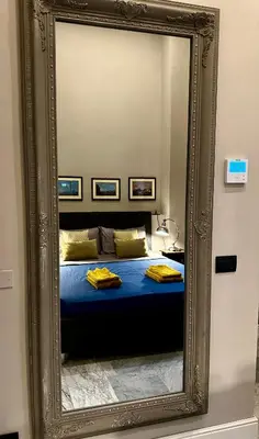 a mirror reflection of a bed in a room at The Great Maison in Rome