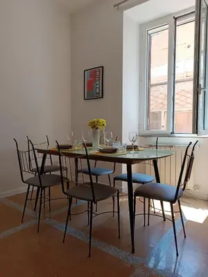 a dining room with a glass table and chairs at Design House Monti in Rome