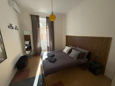 a bedroom with a bed with a wooden head board at Design House Monti in Rome