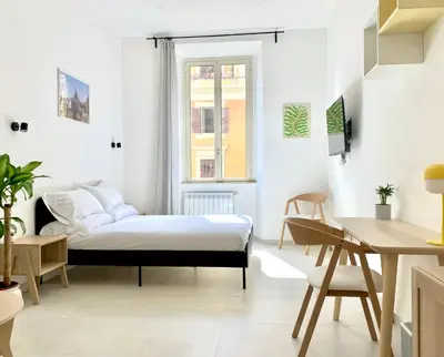 a bedroom with a bed and a desk at Casa Vittoria in Rome