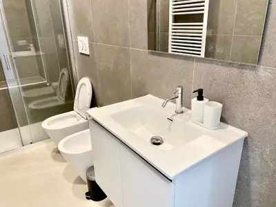 a bathroom with a sink and a toilet and a mirror at Casa Vittoria in Rome