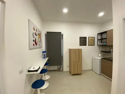 a kitchen with a counter and two stools in a room at Casa Vittoria in Rome