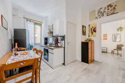 a kitchen and dining room with a table and a dining room at Brandnew luxury house near metro station in Rome