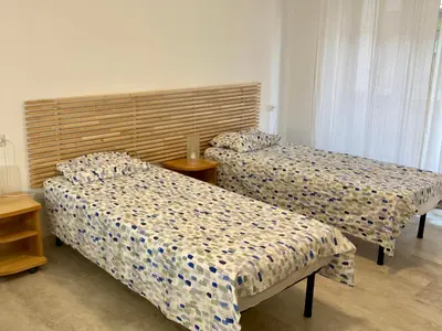 a room with two beds and a table at Brandnew luxury house near metro station in Rome