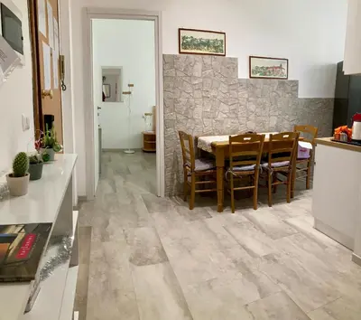 a kitchen and dining room with a table and chairs at Brandnew luxury house near metro station in Rome