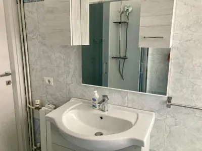 a bathroom with a white sink and a mirror at Brandnew luxury house near metro station in Rome