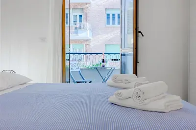 a bedroom with a bed with towels on it at Brandnew luxury house near metro station in Rome