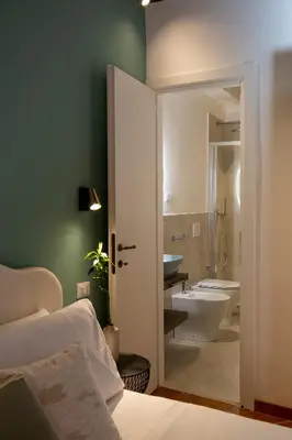 a bedroom with a bathroom with a toilet and a sink at Views of the Coliseum in Rome